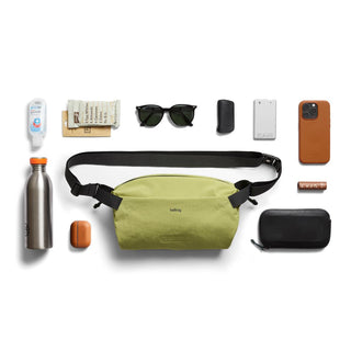 Bellroy Lite Sling in light green made from recycled materials shown with everyday carry essentials