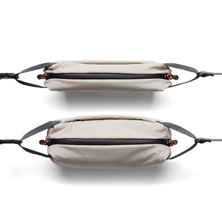 Bellroy Lite Sling Mini in light beige showing top and side views with black zipper and straps