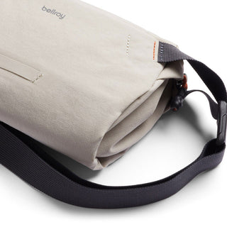 Bellroy Lite Sling Mini in light beige with durable fabric and adjustable dark strap detail close-up view