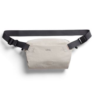 Bellroy Lite Sling Mini in beige water-resistant fabric with adjustable black strap and compact design