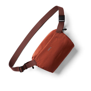 Bellroy Lite Sling Mini in rust color with adjustable fabric strap and water-resistant recycled materials