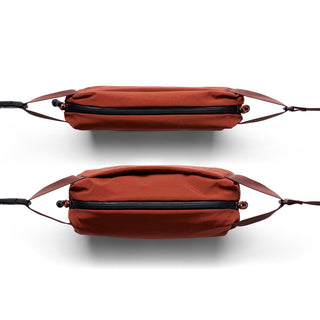 Bellroy Lite Sling Mini in rust color showing slim profile and water-resistant fabric texture