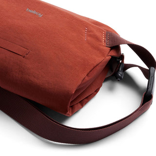 Bellroy Lite Sling Mini in rust red with textured water-resistant fabric and adjustable strap details