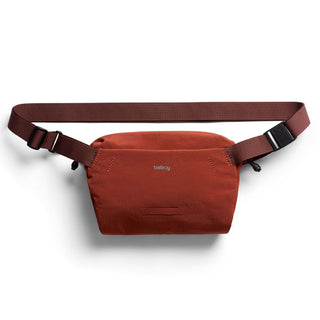 Bellroy Lite Sling Mini in rust red with adjustable strap and water-resistant recycled fabric