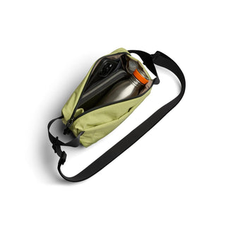 Bellroy Lite Sling Mini in olive green showing water bottle and phone inside durable fabric bag