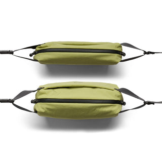 Bellroy Lite Sling Mini in green showing top and side views with black adjustable straps and zippers
