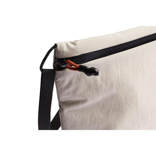Bellroy Lite Sacoche crossbody bag in light beige recycled fabric with black zipper and strap details