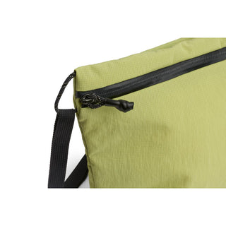 Bellroy Lite Sacoche in green showing water-resistant fabric and black zipper detail close-up
