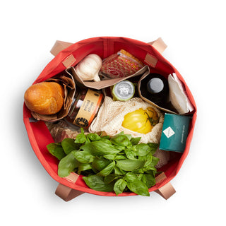 Bellroy Market Tote filled with groceries including fresh basil and bread, shown from top view