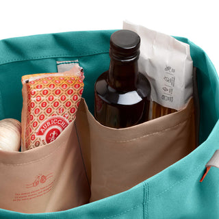 Bellroy Market Tote in teal showing interior organizational pockets with groceries inside