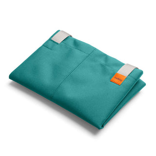 Bellroy Market Tote in teal recycled nylon fabric folded with white handles and orange logo tag visible