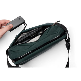Bellroy Venture Sling 6L in dark green showing interior compartments and smooth recycled fabric texture