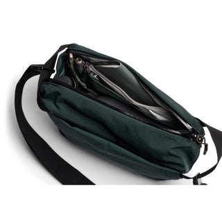 Bellroy Venture Sling 6L in dark green showing organized interior compartments and adjustable strap