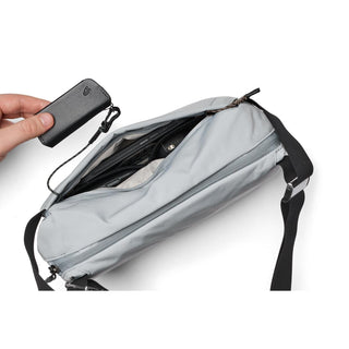 Bellroy Venture Sling 6L in light gray showing interior organization and detachable key clip accessory