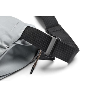 Close-up of black adjustable strap and silver buckle on Bellroy Venture Sling 6L bag in gray fabric