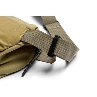 Close-up of Bellroy Venture Sling 6L beige strap with black buckle and durable recycled fabric texture