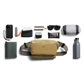 Bellroy Venture Sling 6L in tan recycled nylon displayed with everyday carry items on white background