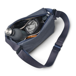 Bellroy Venture Sling 6L in navy blue showing organized interior with water bottle and clothing compartments