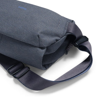 Bellroy Venture Sling 6L in navy blue with textured fabric and adjustable strap details on white background