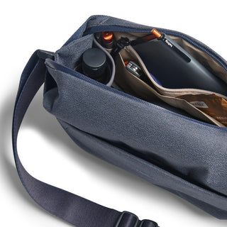 Bellroy Venture Sling 6L navy blue with organized compartments and tech accessories inside