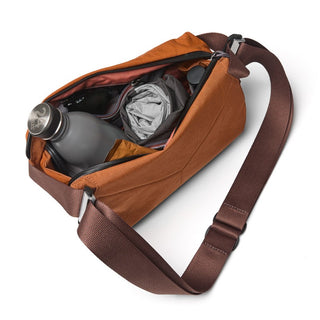 Bellroy Venture Sling 6L in brown with adjustable strap and organized interior compartments including water bottle slot
