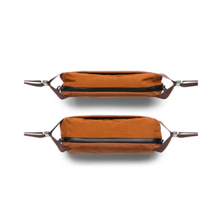 Bellroy Venture Sling 6L in rust orange canvas shown from top and front with brown leather straps