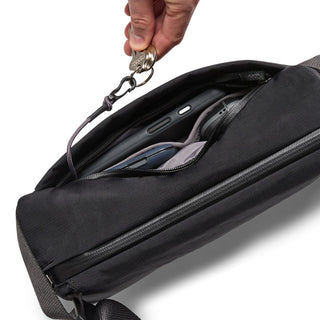 Bellroy Venture Sling 6L black nylon bag with key clip and organized interior compartments visible