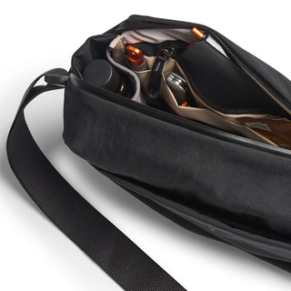 Bellroy Venture Sling 6L in black with organized interior compartments and durable strap visible from above angle