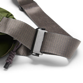 Bellroy Venture Sling 6L close-up of gray woven strap with metal buckle and green fabric edge