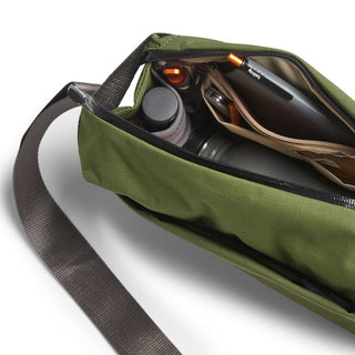 Bellroy Venture Sling 6L in olive green with organized interior compartments and brown adjustable strap