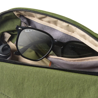 Bellroy Venture Sling 6L in olive green fabric with a sunglasses compartment and beige lining visible