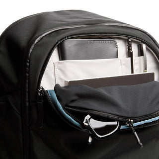 Bellroy Transit Workpack Pro 22L in black with organized front pocket holding leather wallet and pens