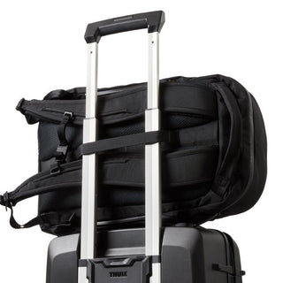 Bellroy Transit Workpack Pro 22L black backpack secured on suitcase handle showing padded straps and back panel