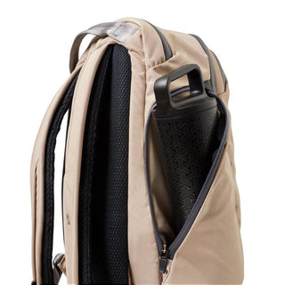 Bellroy Transit Workpack Pro 22L beige backpack side view showing water bottle pocket and padded straps