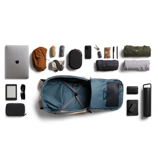 Bellroy Transit Workpack Pro 22L open with various organized travel and tech essentials laid out on white background