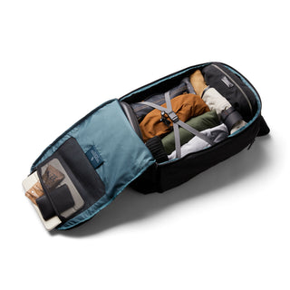 Bellroy Transit Workpack Pro 28L in black with organized packed clothes and tech accessories inside