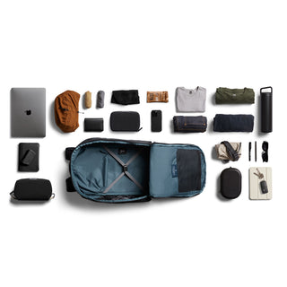 Bellroy Transit Workpack Pro 28L open with organized tech and clothing items in blue interior lining