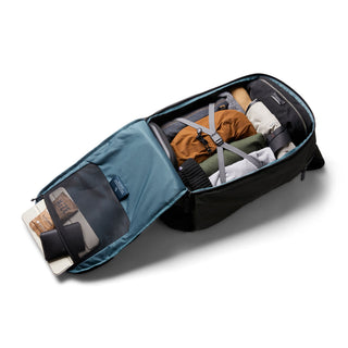 Bellroy Transit Workpack Pro 28L open with packed clothes and organized compartments in black fabric design
