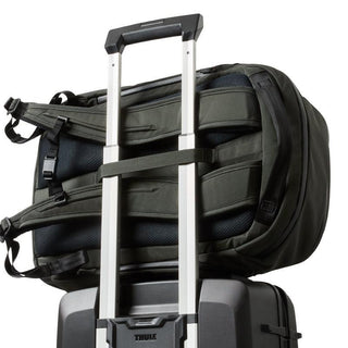 Bellroy Transit Workpack Pro 28L draped over suitcase handle showing padded back and straps in olive green