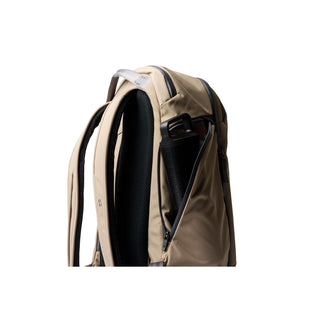 Bellroy Transit Workpack Pro 28L in tan showing side pocket with water bottle and padded shoulder straps