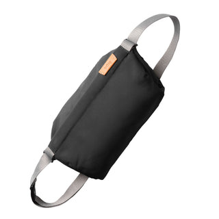 Bellroy Sling - 7L in black woven fabric with eco-tanned leather detail and adjustable grey strap