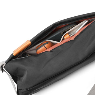 Bellroy Sling - 7L showing organized interior pockets with tech accessories and water-resistant fabric