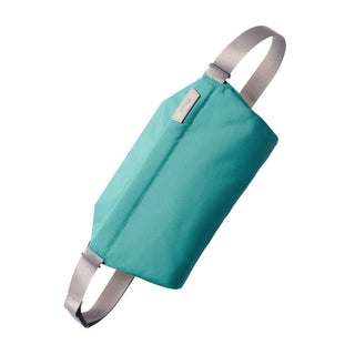 Bellroy Sling - 7L in teal woven fabric with adjustable beige straps and minimalist design