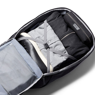 Bellroy Transit Backpack open showing organized packed clothes, shoe, and accessories inside compartments