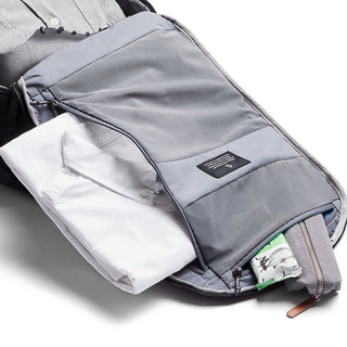 Bellroy Transit Backpack in gray showing organized interior with folded shirt and zipped compartments