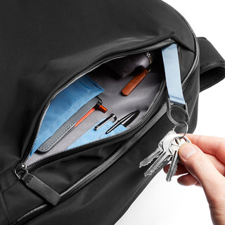 Bellroy Transit Backpack showing organized interior pockets and key holder with durable black fabric exterior