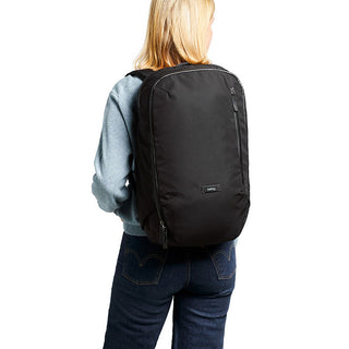 Bellroy Transit Backpack in black recycled fabric worn by a person from the back angle