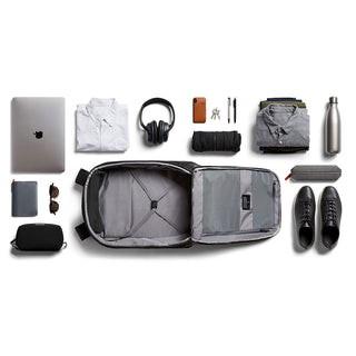 Bellroy Transit Backpack open with organized essentials including laptop, shoes, clothes, and accessories displayed flat