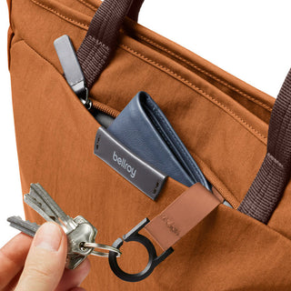 Bellroy Tokyo Tote Compact in rust brown woven fabric with leather keyring and external pocket detail