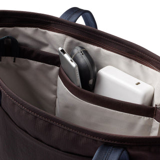 Bellroy Tokyo Tote Compact showing organized interior pockets with tech accessories in brown fabric